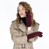 Woman wearing cable knit gloves in damson