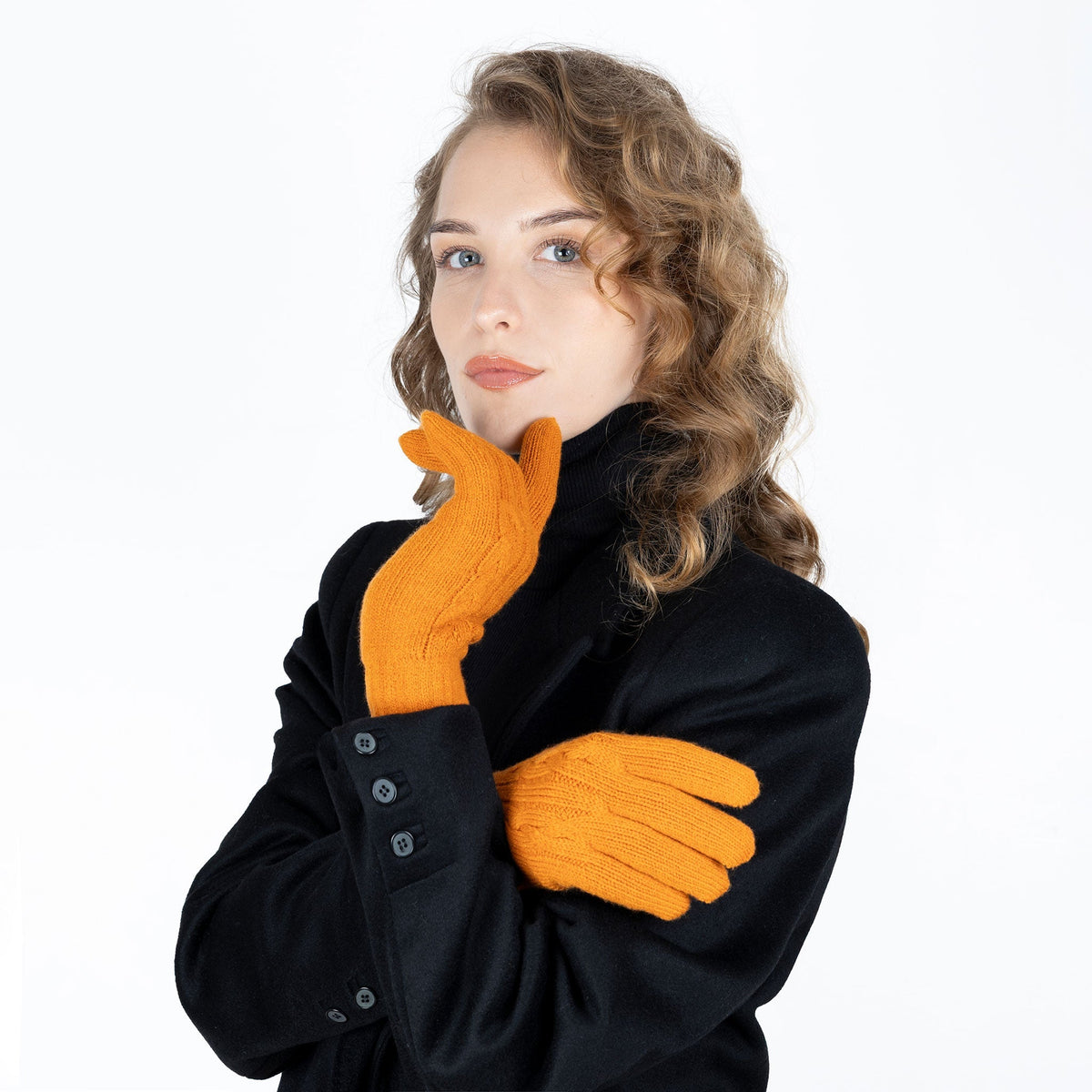 Woman wearing cable knit gloves in pumpkin