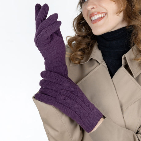 Woman wearing cable knit gloves in amethyst