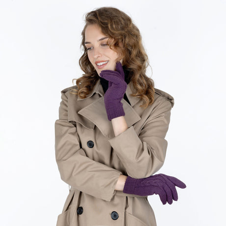 Woman wearing cable knit gloves in amethyst