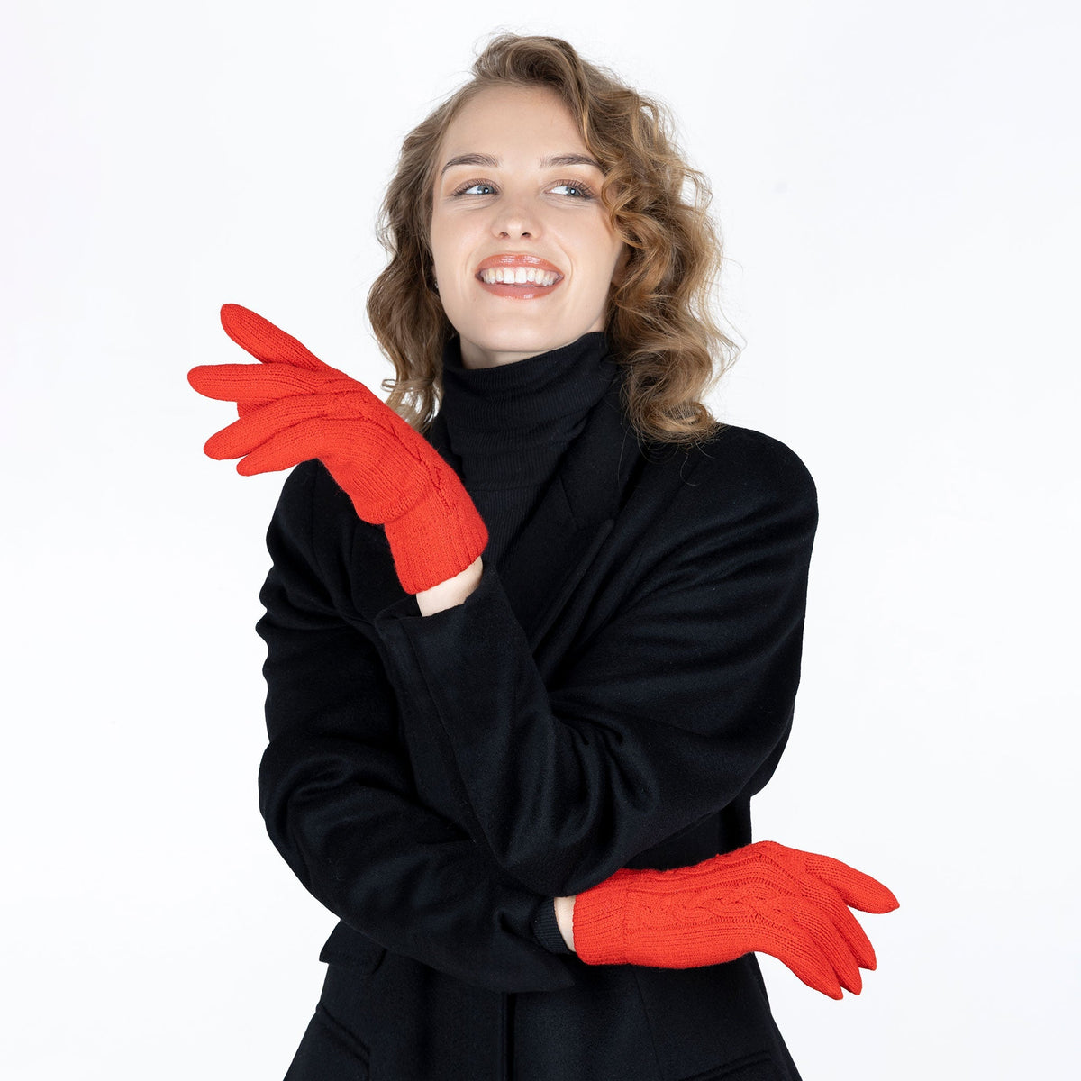 Woman wearing cable knit gloves in berry