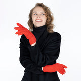 Woman wearing cable knit gloves in berry