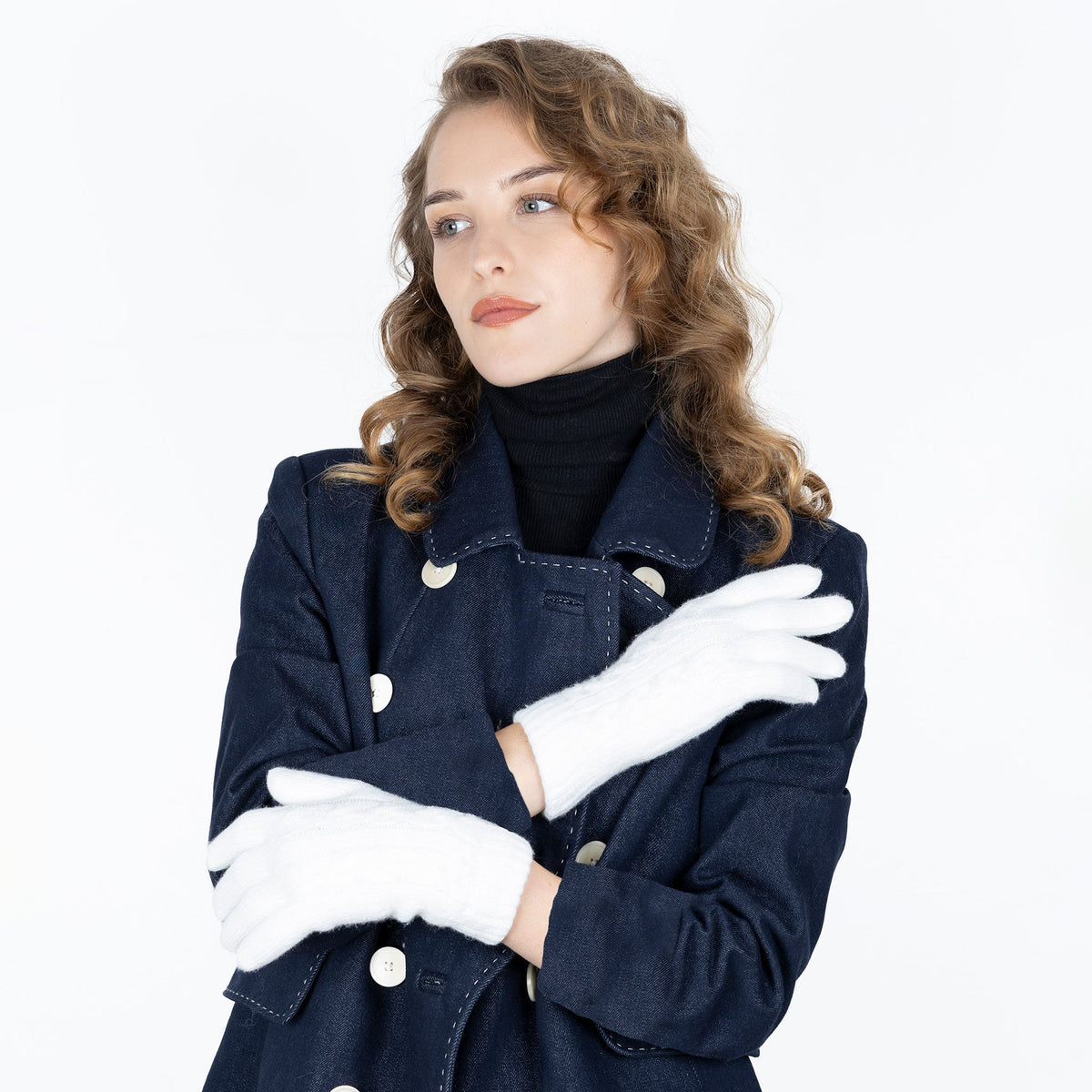 Woman wearing cable knit gloves in winter white
