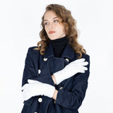 Woman wearing cable knit gloves in winter white
