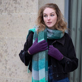woman wearing cable knit gloves in purple whilst out for a walk