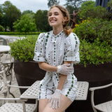 Woman wearing cotton crochet gloves in ecru sitting outdoors