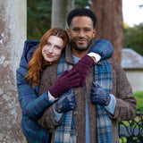 Woman wearing knitted gloves in burgundy embracing in a hug with her partner