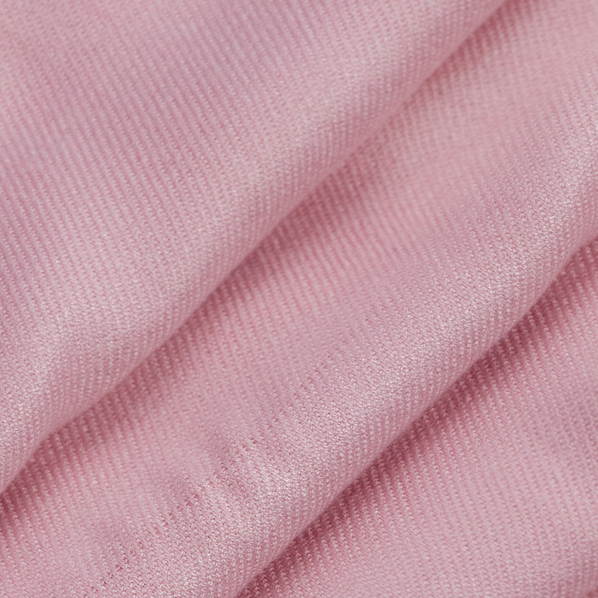 Close up of a folded women's plain pashmina shawl in pale pink