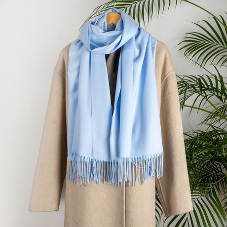 Women's plain pashmina in pale blue on a camel coat 