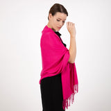 Woman wearing plain pashmina shawl in fuchsia - draped over her shoulders