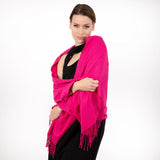 Woman wearing plain pashmina shawl in fuchsia - draped over her shoulders