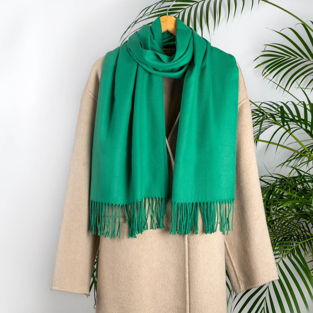 Women's plain pashmina in emerald on a camel coat 