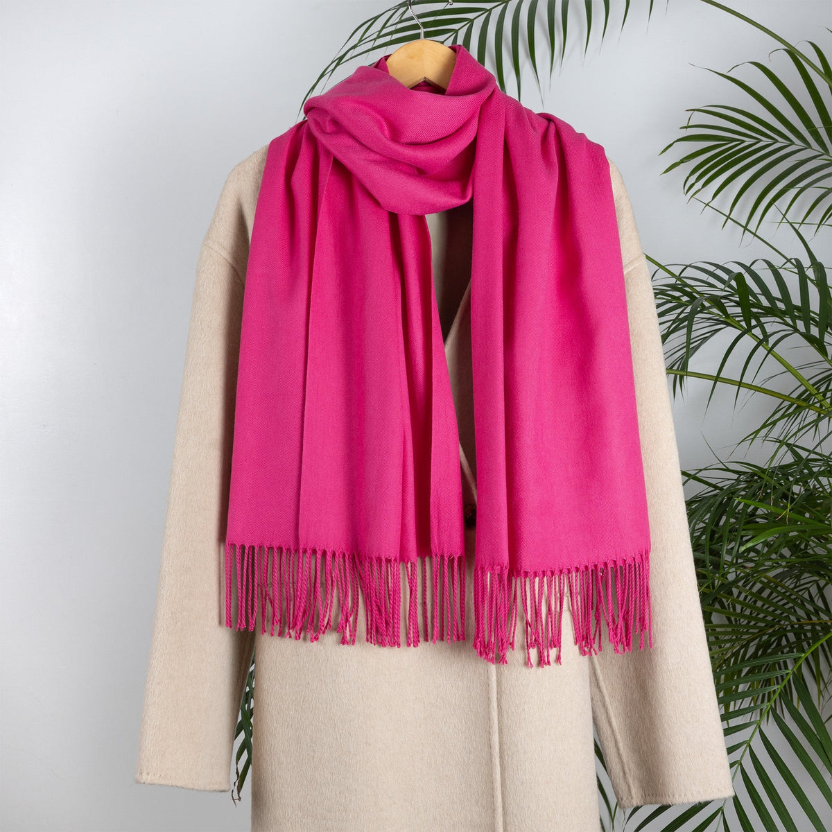 Women's plain pashmina in hot pink on a camel coat 
