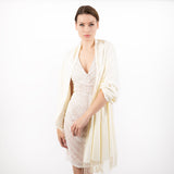 Woman wearing plain pashmina shawl in ivory - draped over her shoulders