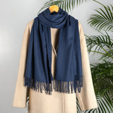 Women's plain pashmina in navy on a camel coat 