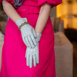 Woman wearing silk-lined leather gloves in silver 